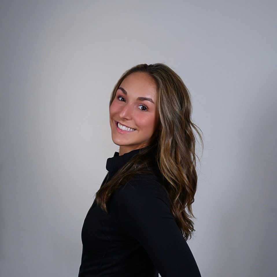 Jacqui, instructor at The Studio Portsmouth, smiling in a black jacket
