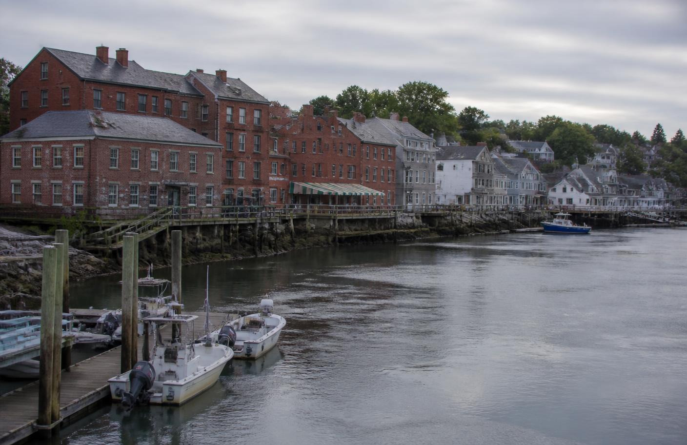 Brick waterfront buildings and small boats along the Piscataqua River in Portsmouth